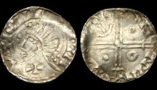 AR Penny. Phase V coinage, ca.1065-96AD, ca.17mm, ca.0.7g. Draped bust left; large cross pattée on neck; blundered and illegible legend around / Voided long cross, with triple crescent ends; pellet, annulet, pellet, and inward-facing anchor in angles; blundered and illegible legend around. S6138